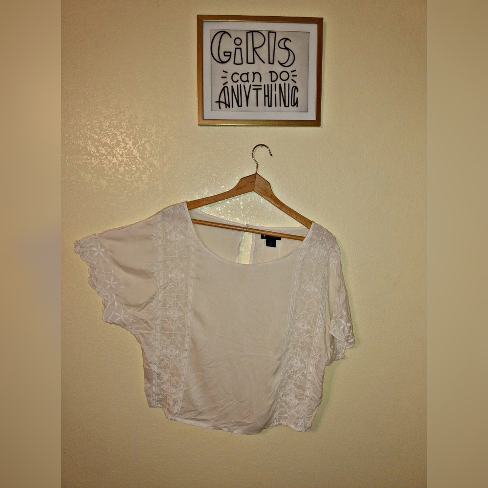 White blouse with some flowers.